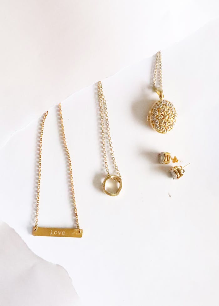 Beautiful assortment of gold jewelry including necklaces, earrings, and pendants.